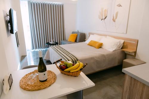 a room with a bed and a basket of fruit on a table at MAGNOLIA SUITES in Nafpaktos