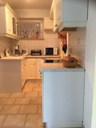 a kitchen with white cabinets and a counter top at Haus-Petra-Maria in Bad Schlema