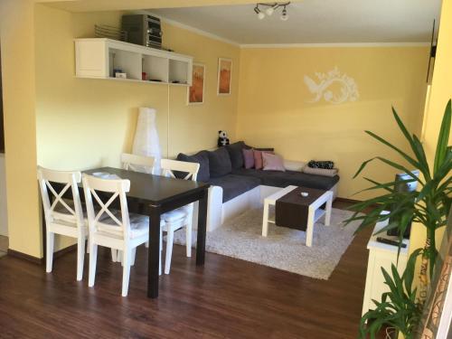 a living room with a couch and a table and chairs at Haus-Petra-Maria in Bad Schlema