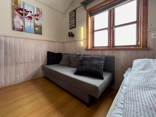 a small room with a couch and a window at Gotta Cottages in Selfoss