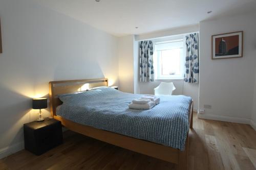 een slaapkamer met een bed met twee handdoeken erop bij Fabulous East Finchley in Londen