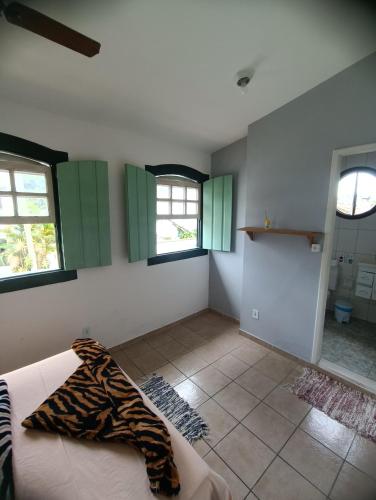 a room with green cabinets and a tiled floor at Suítes da Val in Paraty