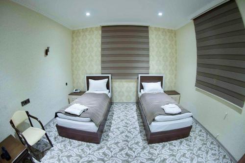 a room with two beds in a room with at MUGHAN PARK HOTEL in Sabirabad