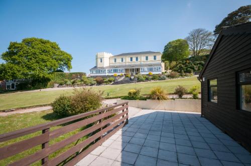a driveway leading to a house with a fence at Kingswear Park Club with Swimming Pool & Spa in Kingswear