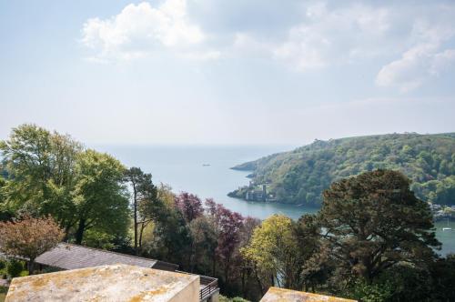 a view of a body of water with trees at Kingswear Park Club with Swimming Pool & Spa in Kingswear