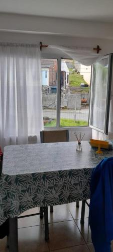 Una mesa en una habitación con ventana en MyR alojamientos 2 en Ushuaia