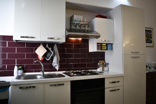a kitchen with a sink and a stove top oven at La Terrazza sul Tempio in Brindisi