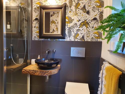 a bathroom with a sink and a shower at Kettle Tree Cabin in Welshpool