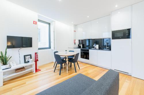 a kitchen and dining room with a table and chairs at Porto Santa Maria Apartments in Porto