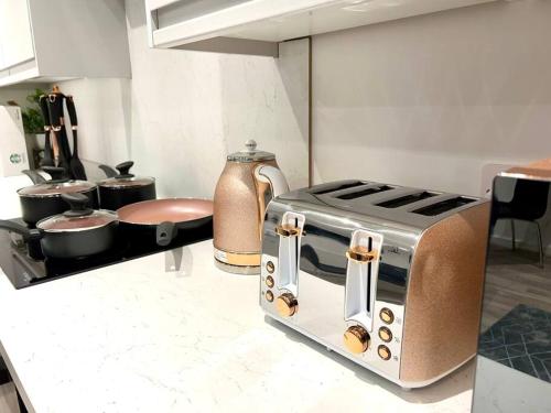 a kitchen with a toaster and pots and pans at 2 bed Penthouse in Liverpool City Centre in Liverpool