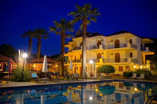 a resort with a swimming pool at night at Irida Rooms 'n' Pool - Cozy Summer Escape in Paralia Panteleimonos