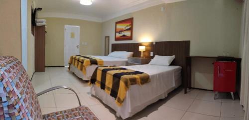 En eller flere senger på et rom på Pousada Itarema Residence