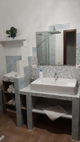 a bathroom with a sink and a mirror at CIVICO 16A - Apartment - with private parking in Quartu SantʼElena
