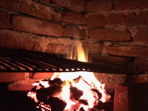 a brick oven with a fire in it at Cabin mountain view near Ponce slepts 8 in Ponce