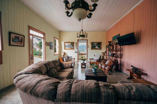 a living room with a couch and a table at Cabin mountain view near Ponce slepts 8 in Ponce