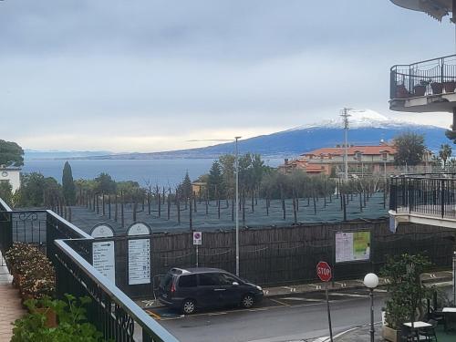 a car parked in a parking lot next to a body of water at The White Lodge in Sorrento