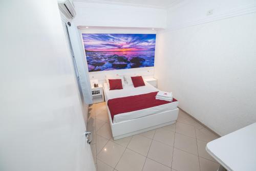 a small room with a bed and a painting on the wall at Expo Hotel in Sao Paulo