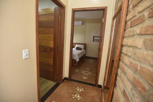 a hallway with a mirror and a bed in a room at Sítio do Bosco Park in Tianguá