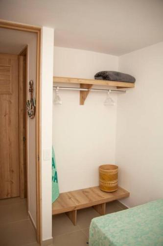 a room with a bed and a wooden shelf at Apartamento Duplex - Aqua Guatape in Guatapé