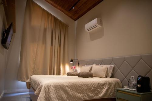 a bedroom with a bed and a window with a heater at Sítio do Bosco Park in Tianguá