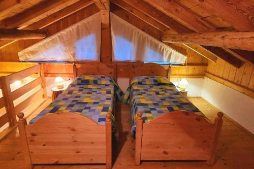 a bedroom with two beds in a cabin at Maso Brunetto in Canale San Bovo