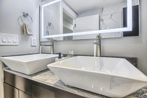 a bathroom with two white sinks on a counter at Charming and Luxurious 2BR+1Bath Guest Suite in Toronto