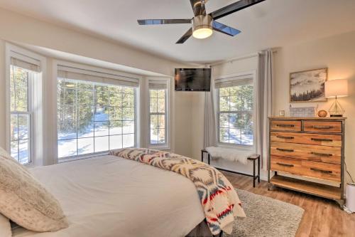 a bedroom with a bed with a ceiling fan and windows at Nomad Haus with Mtn Views and Deck - 25 Mi to Breck! in Fairplay