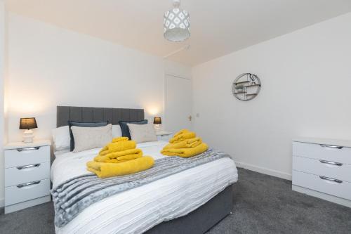 a bedroom with a bed with yellow towels on it at Central City Stay - 1 Bed Apartment in Aberdeen in Aberdeen