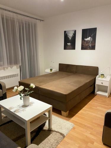 uma sala de estar com uma cama grande e uma mesa em Studio 101 Fatrapark 1 Ružomberok em Ruzomberok
