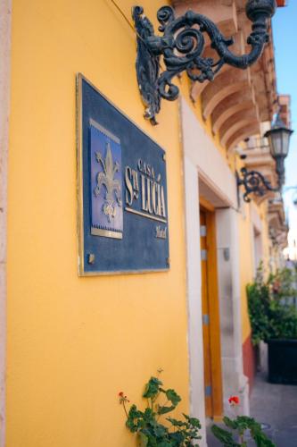 a sign on the side of a building at Hotel Casa Santa Lucia in Zacatecas