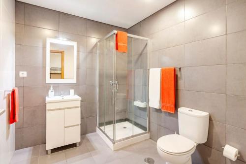 a bathroom with a shower and a toilet and a sink at Casa de Balinhas - Gerês in Cova