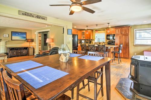 a kitchen and living room with a dining room table at Walk to Beach Maine Home with Hot Tub and Deck! in Old Orchard Beach