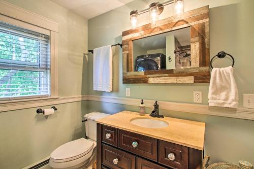 a bathroom with a sink and a toilet and a mirror at Walk to Beach Maine Home with Hot Tub and Deck! in Old Orchard Beach