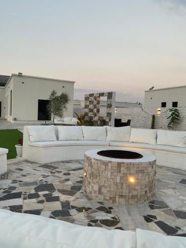 a living room with a couch and a fire pit at Seagemfuj in Fujairah