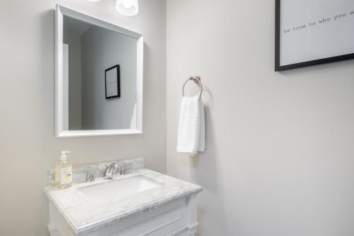a white bathroom with a sink and a mirror at Modern Stunning SouthPark/Cotswold Home! in Charlotte