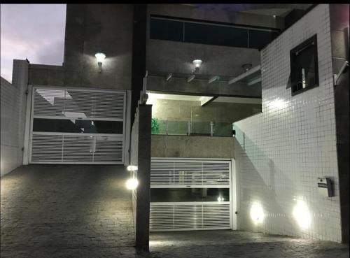 um edifício com uma garagem com luzes em Apartamento Cidade Ocian - Praia Grande - Edifício Van Gogh - Alto padrão 94mts - 2 Suítes na Praia Grande