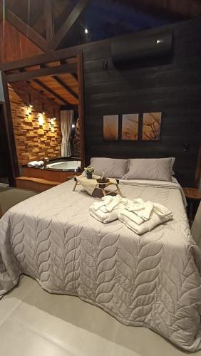 a bedroom with a bed with two towels on it at Refugio Grummel Wald in São Bonifácio