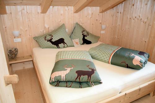 a room with two beds in a wooden cabin at Chalet zum Feldalphorn Prädasten WILD605 in Schwarzenau