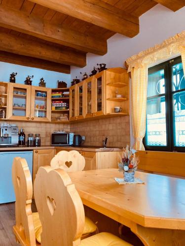 a kitchen with a wooden table and chairs at Chalupy Betlém Hlinsko in Hlinsko