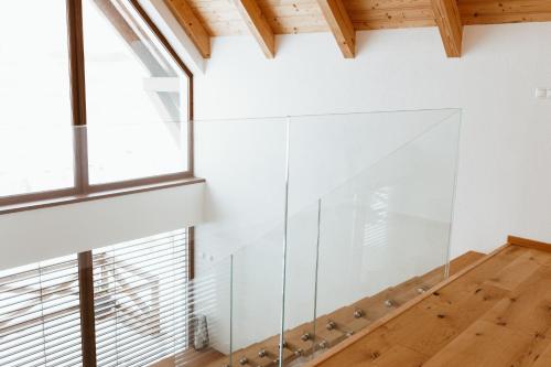 a glass staircase in a room with a window at Villa Štít Stará Lesná in Stará Lesná