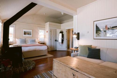 a bedroom with a bed and a living room with a couch at Nick's Cove in Marshall