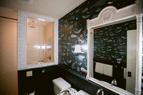 a bathroom with a sink and a toilet and a window at Nick's Cove in Marshall