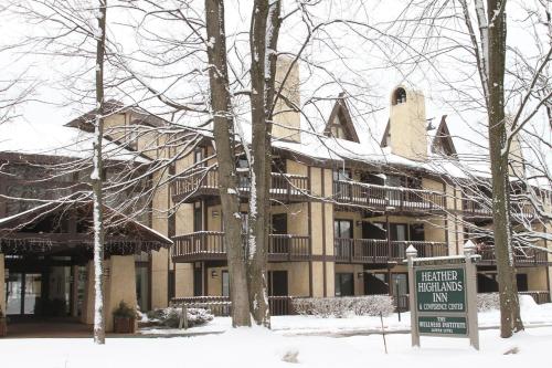 a large building with a sign in the snow at The Highlands at Harbor Springs in Harbor Springs