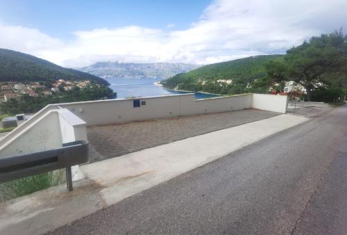 a road with a view of a body of water at The White House, Brac in Pučišća