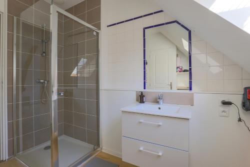 a bathroom with a shower and a sink and a mirror at Casa Nostra - Arrière Gare in Arras