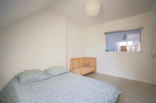 a white bedroom with a bed and a window at Casa Nostra - Arrière Gare in Arras