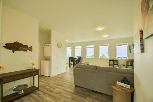 a living room with a couch and a dining room at Rockfish Retreat at Kachemak Bay Kabins in Homer