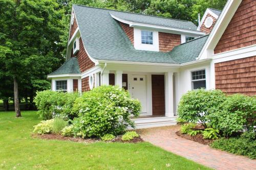 a house with a green roof and a grass yard at The Highlands at Harbor Springs in Harbor Springs