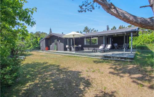 a house with a patio and a backyard at Cozy Home In Samsø With Kitchen in Nordby