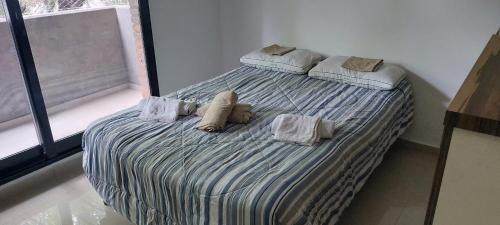 un dormitorio con una cama con dos animales de peluche en Alquiler Temporario Rosario 8 en Rosario